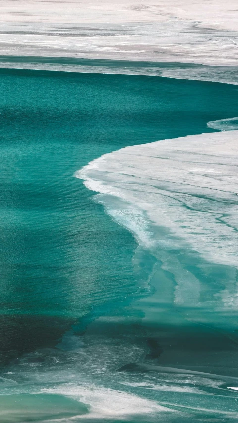 the beach has two people on their surfboards near water