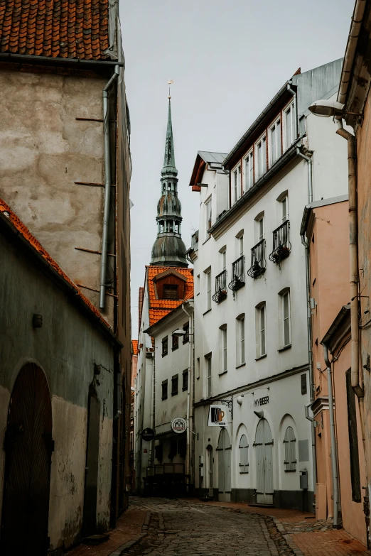 the streets with many buildings line with an old town clock