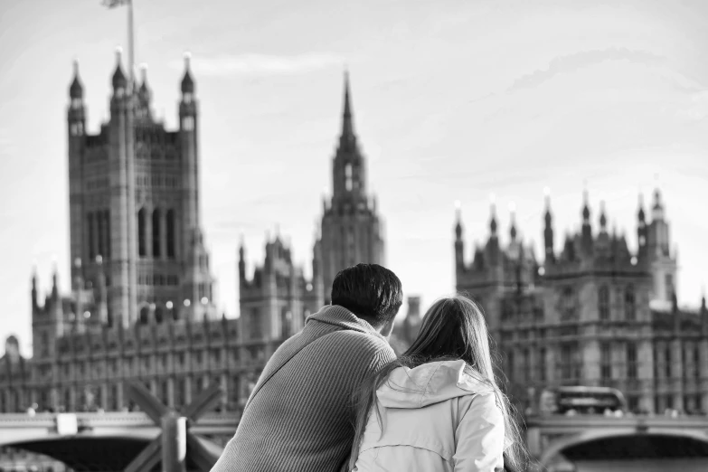 a man and woman on the street in front of a castle