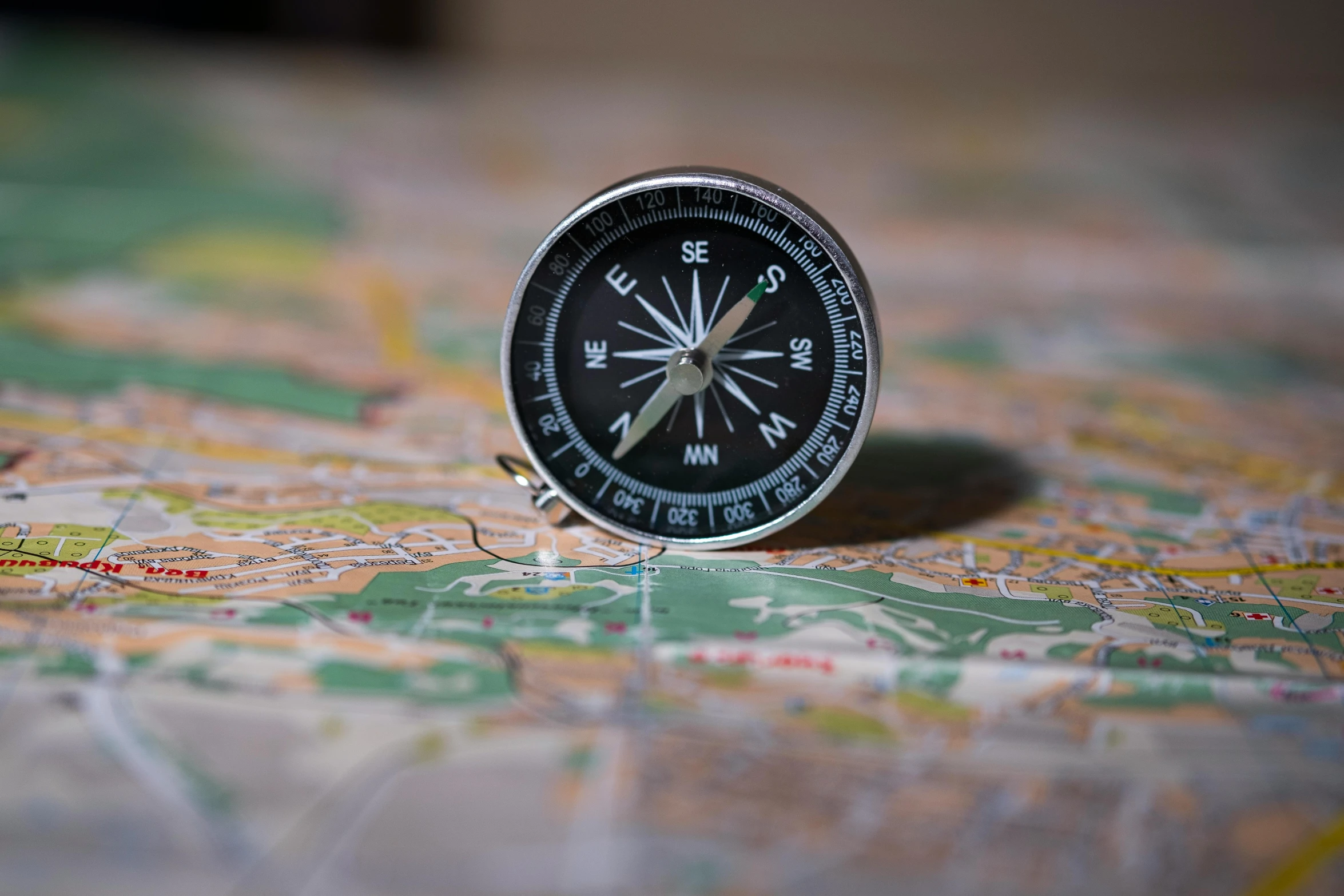 a compass on a map with focus on the ground