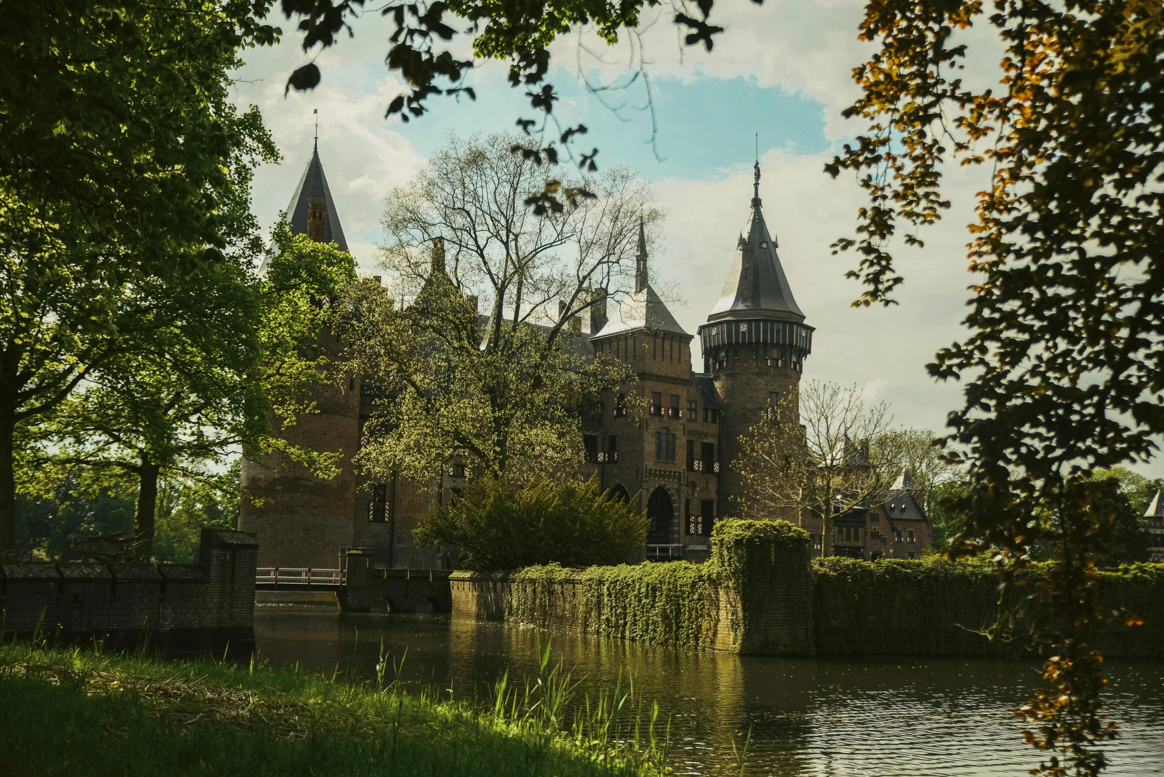 a large church on a small island surrounded by green trees