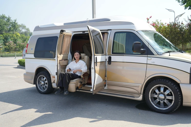 an old lady in white dress sitting in a van