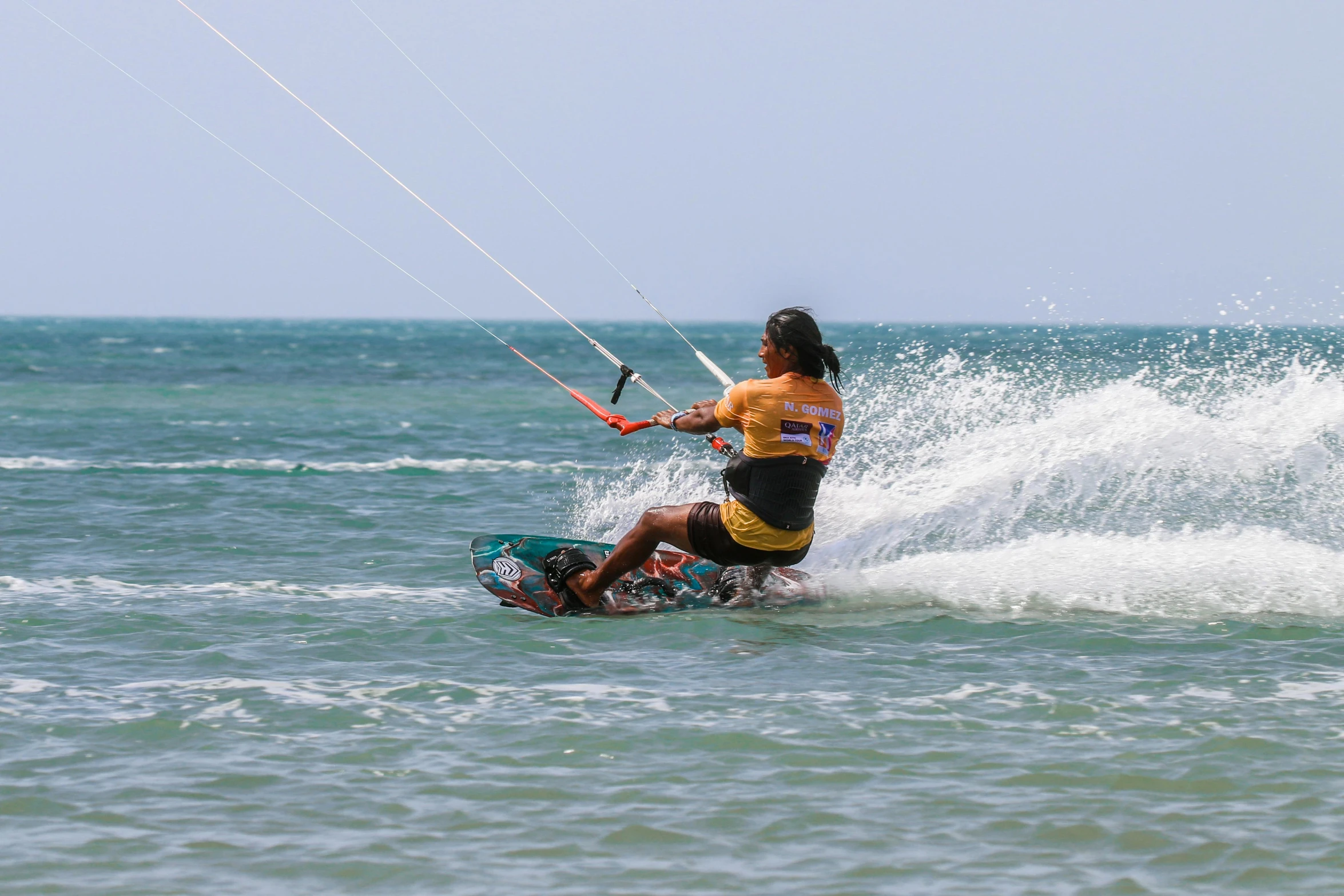 the man is on the surf board riding on the water