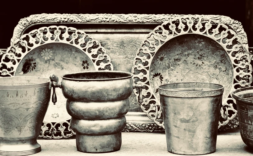 antique metal containers lined up on a table