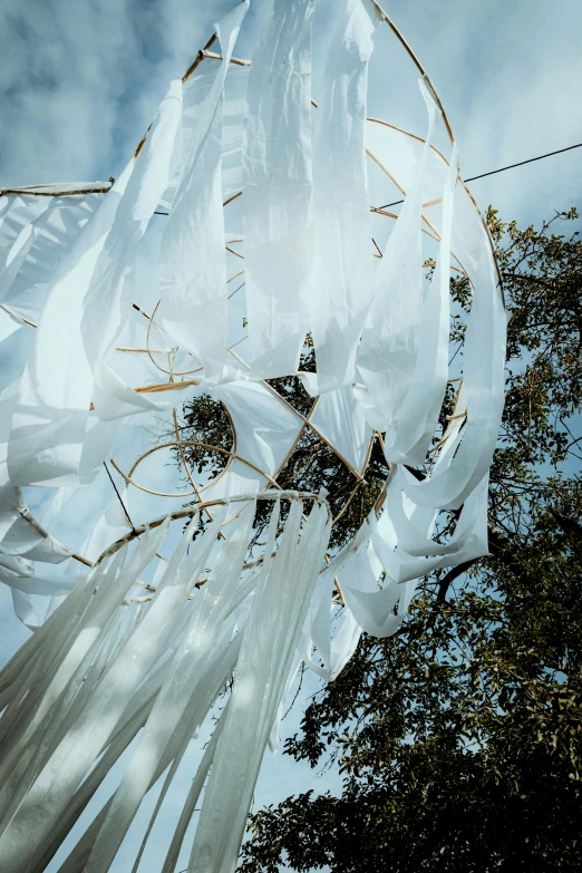 a wind sculpture with several sails hanging off of it