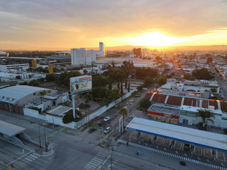 a city street is shown at sunset from above