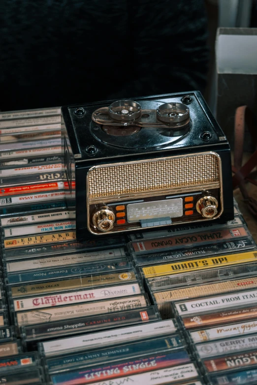 a radio sitting on top of stacks of cds