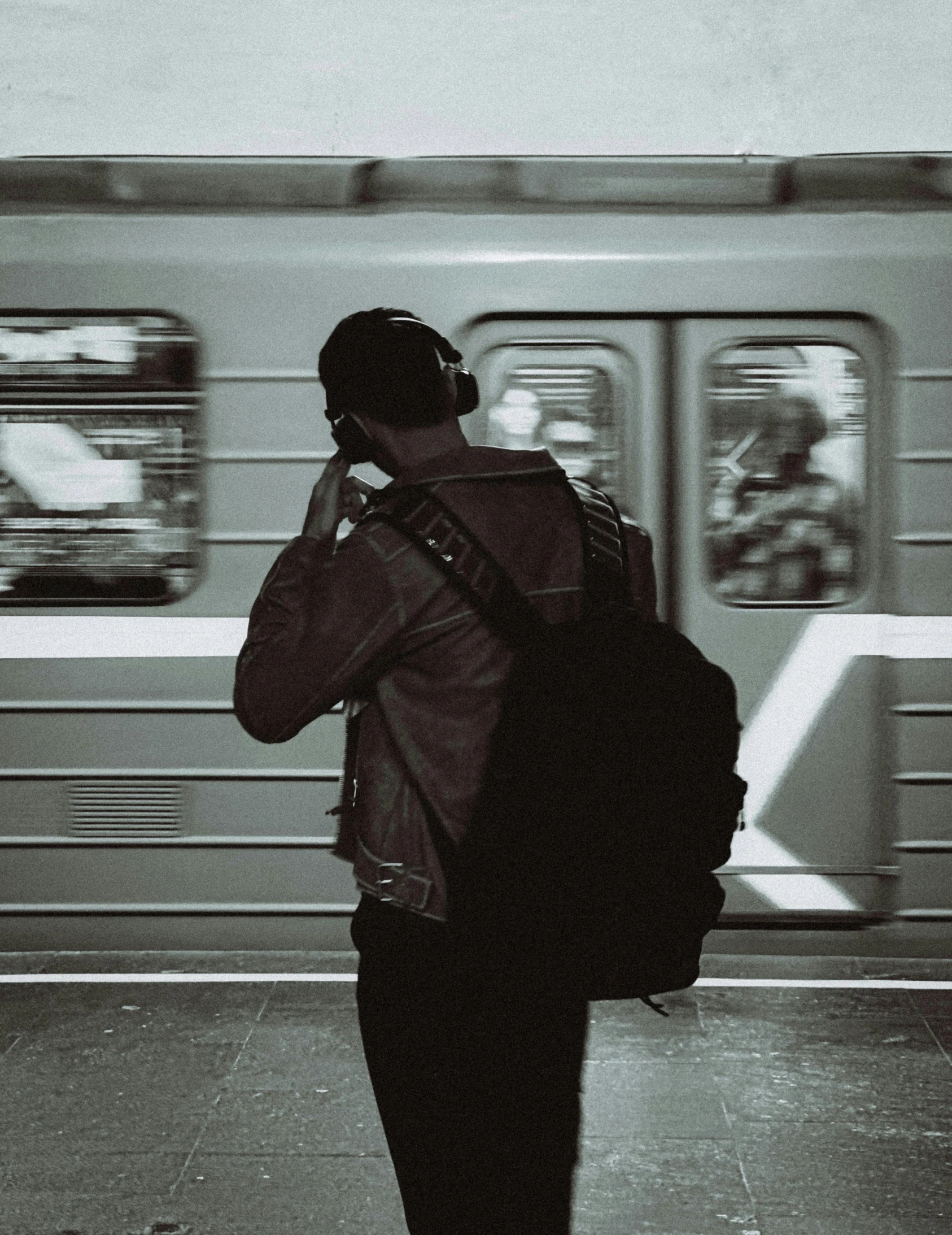 man using his cell phone at the subway station