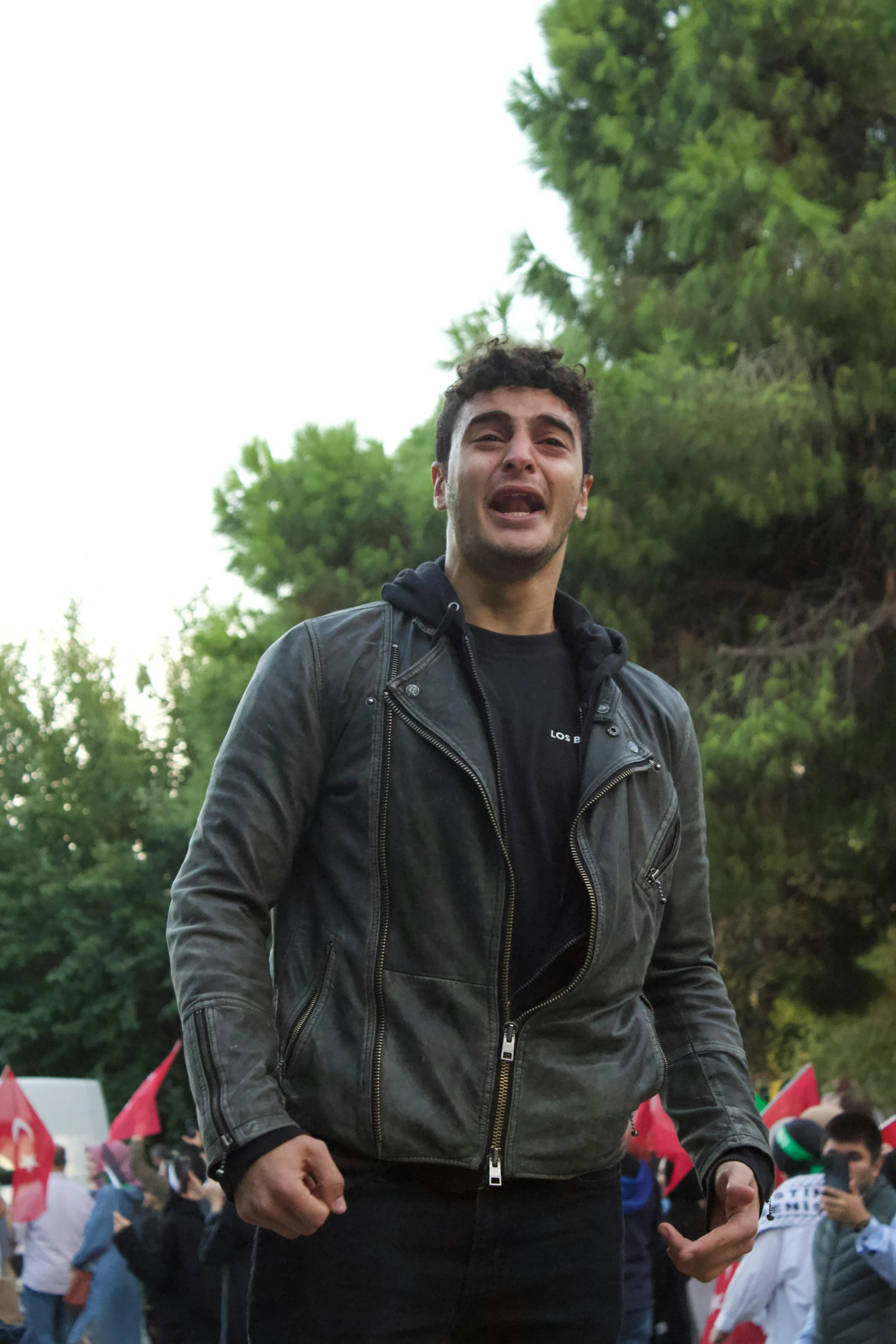 a man standing in front of several people outside