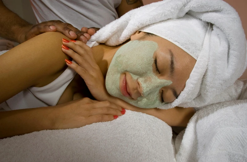 a young woman enjoying a facial mask in a spa