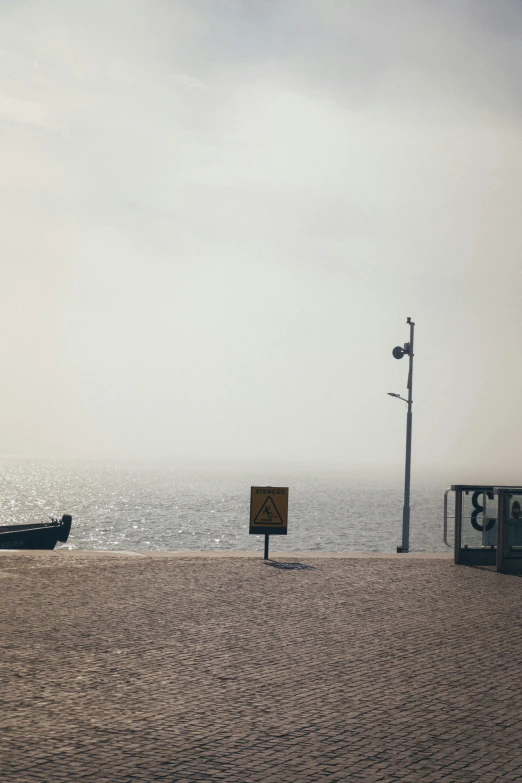 a truck driving down a street next to the ocean