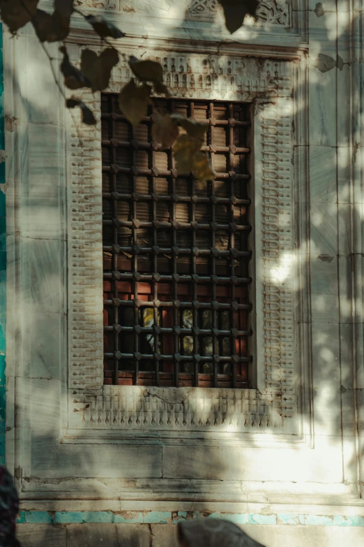 a white building with an iron grille in the door