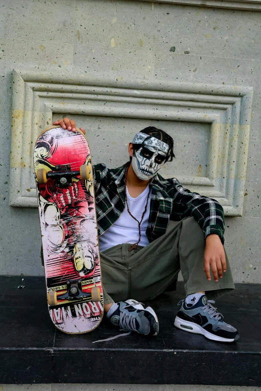 there is a skateboard that is on the ledge with graffiti painted on it