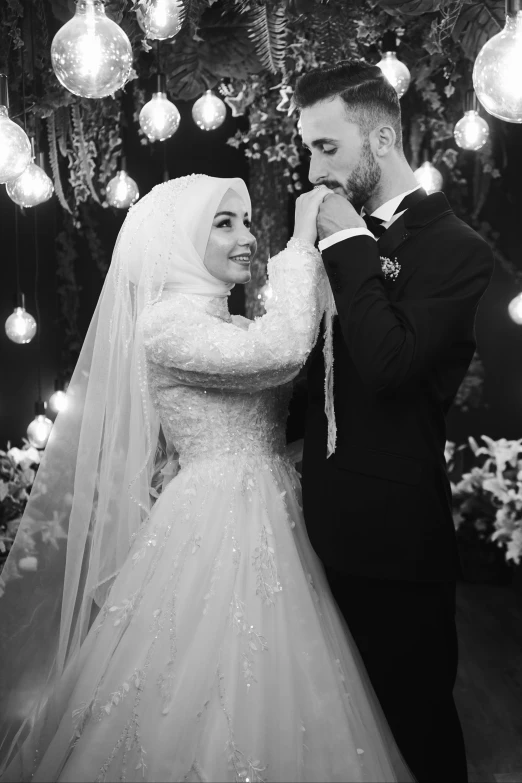 black and white po of bride and groom looking at each other