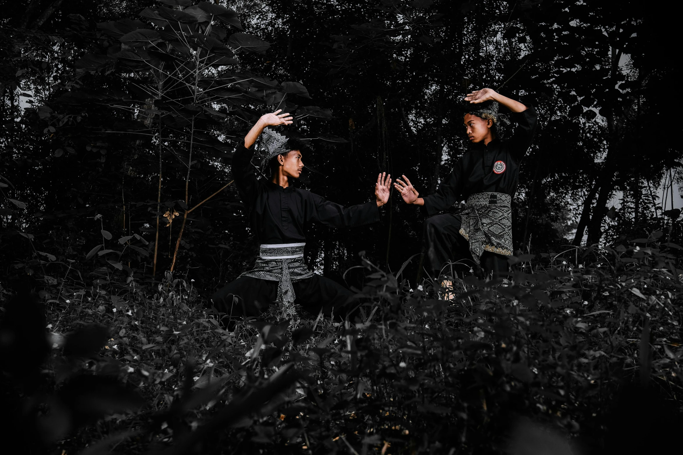 two asian girls in black dress are playing frisbee