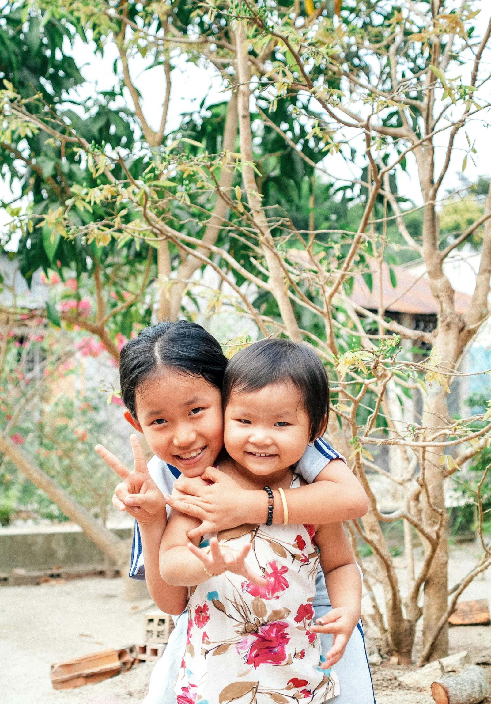 two asian children hug each other for a po