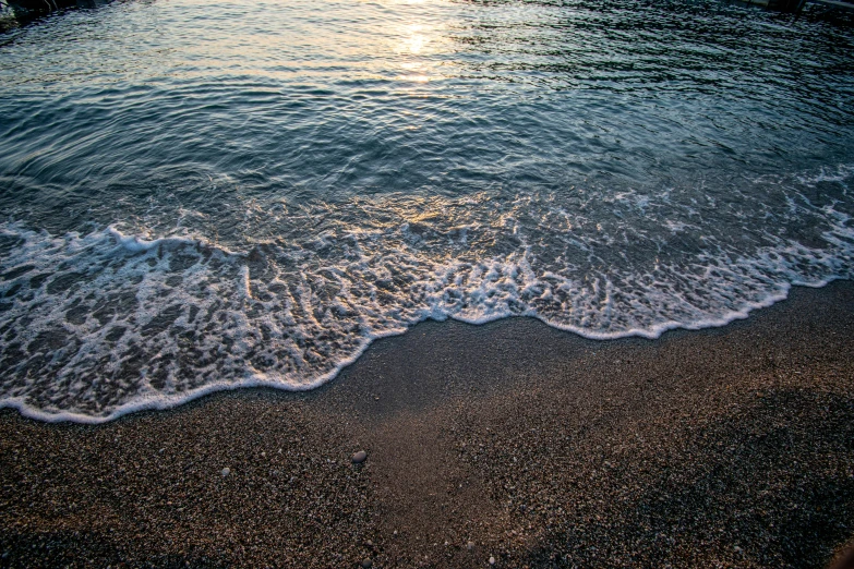 an ocean with small waves coming into the shore