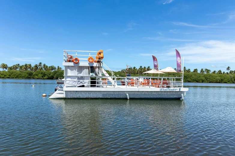 a boat with people on top floating on the water