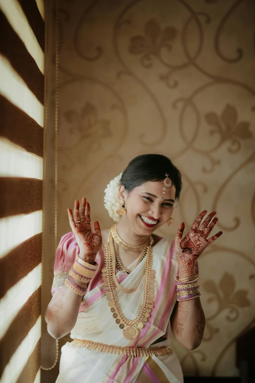 a bride is in a sari and smiling