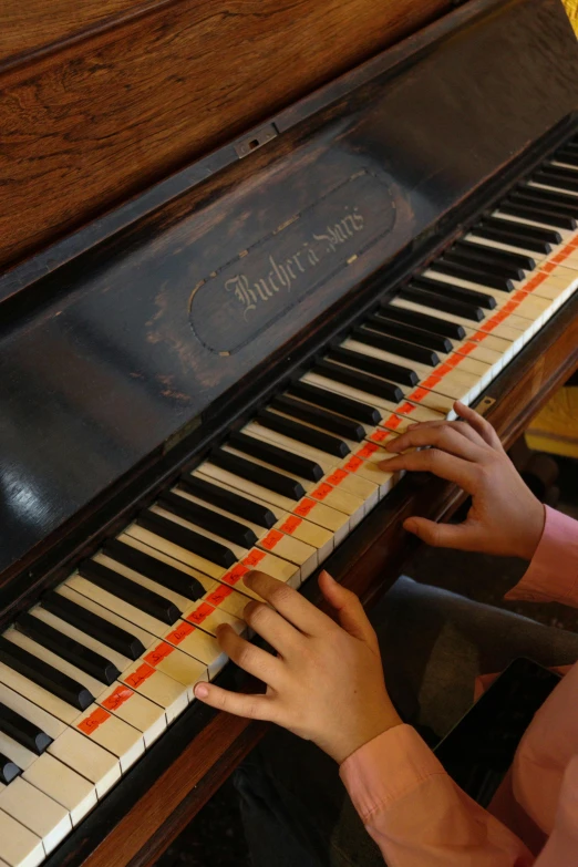 two children touching on the keys of a piano