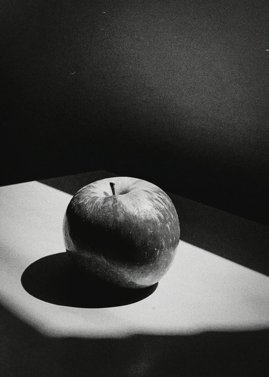 a apple is sitting on top of a surface