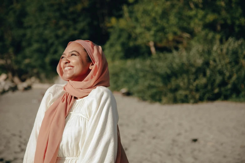 a young woman in white is standing on a beach