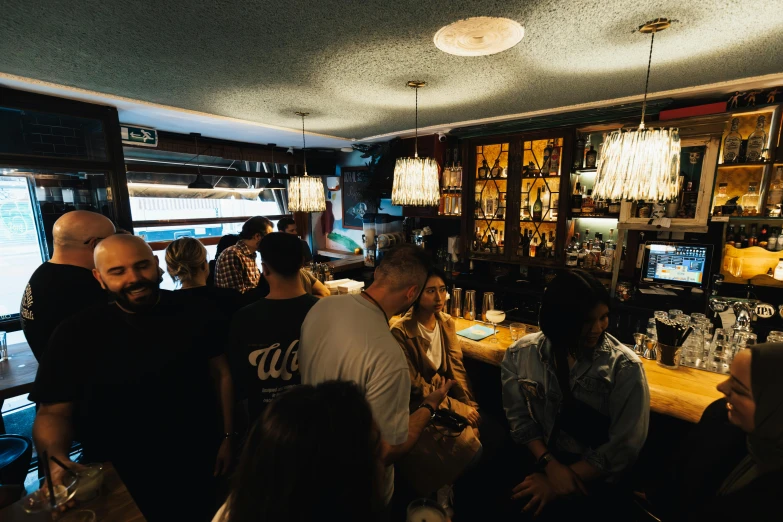 a group of people gather at a bar