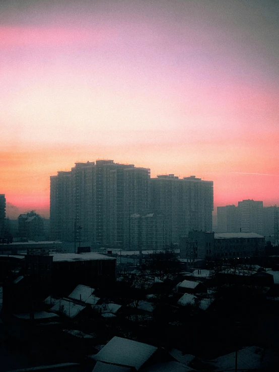 buildings under a very colorful sky with a sky line and a sunset