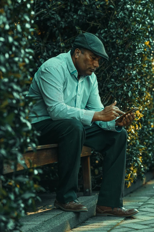 a man that is sitting down on a bench