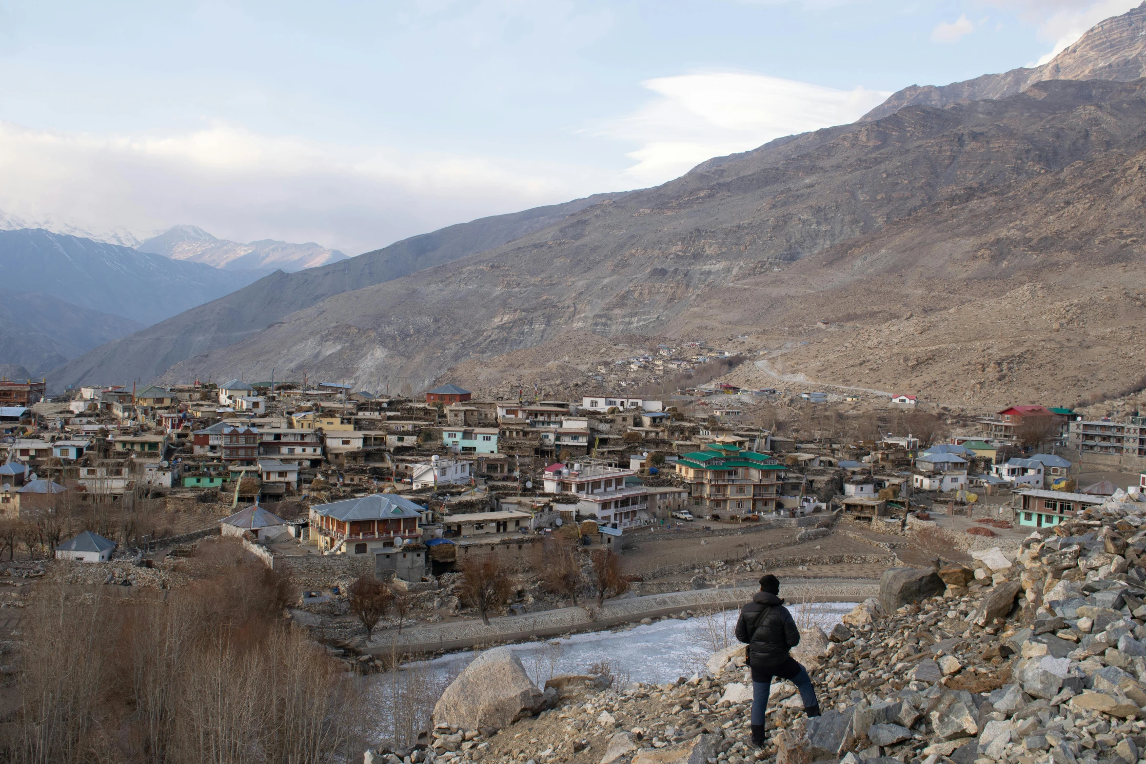 the man is looking at the mountains in front of him