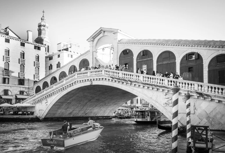 several people on top of a bridge over water