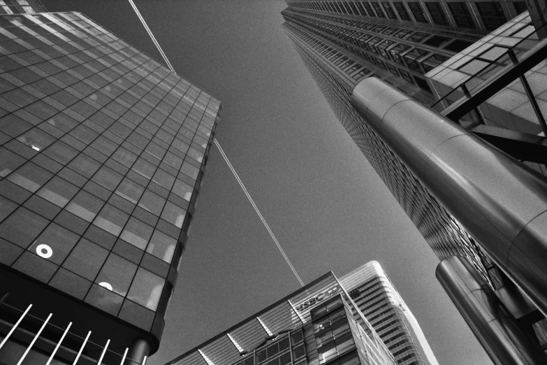 black and white pograph of some buildings and an airplane