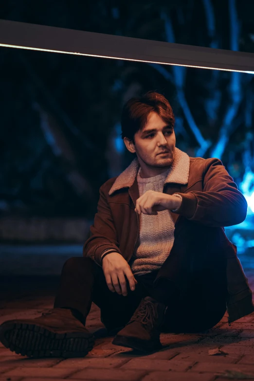 a man sitting on the ground in a building