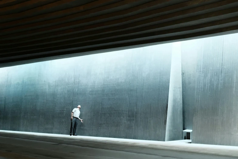 a man is walking across an indoor walkway