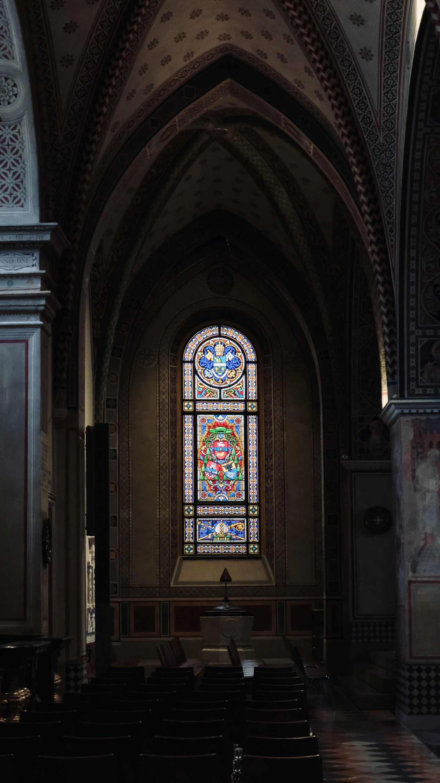 a large stained glass window in an old church