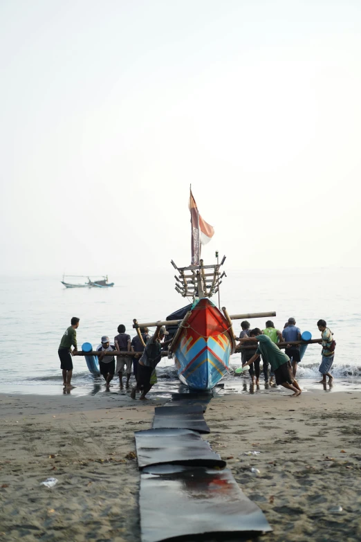 a boat on the shore with people at it