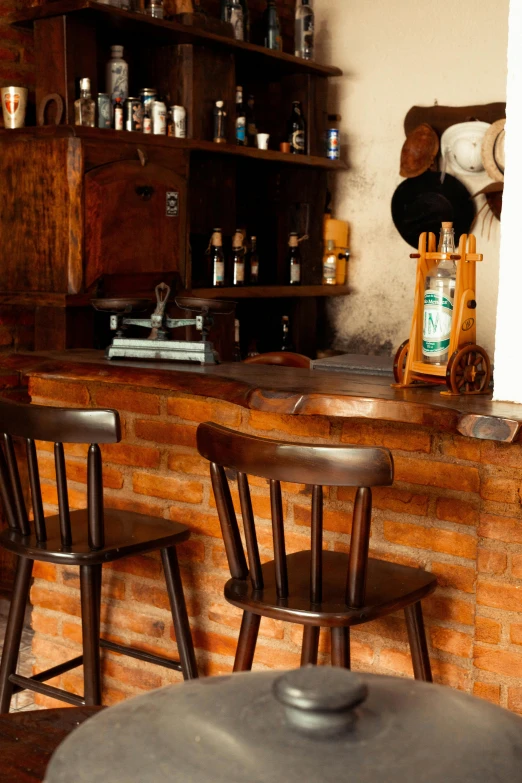 a table with four chairs near a brick counter