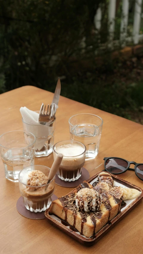 some glasses a spoon and coffee on a table