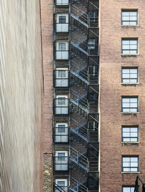 an outdoor stairway next to a building near tall windows