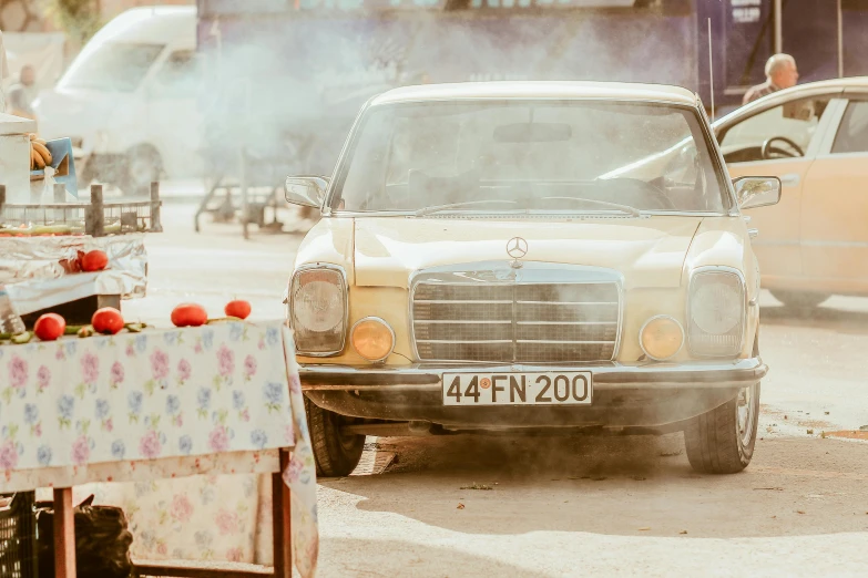 an old car that is driving down the street