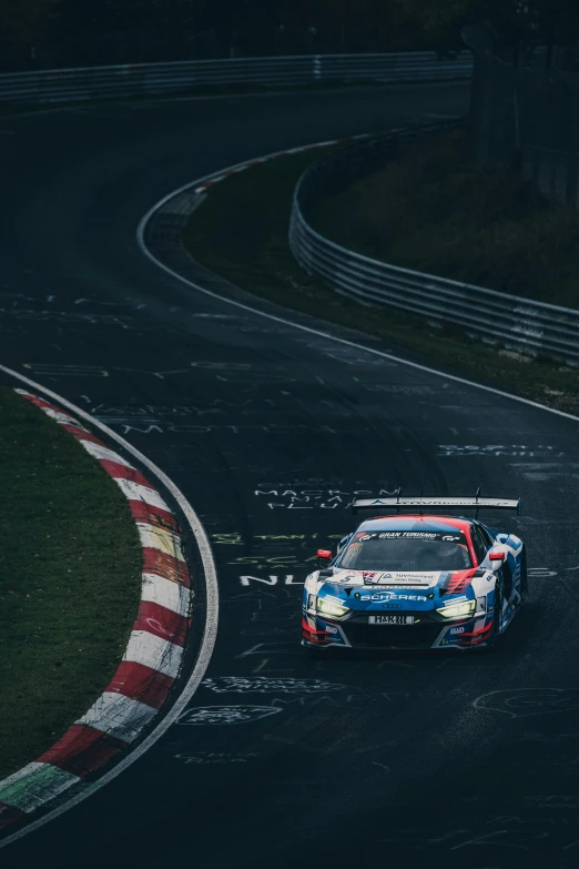 a blue car is driving down the winding road