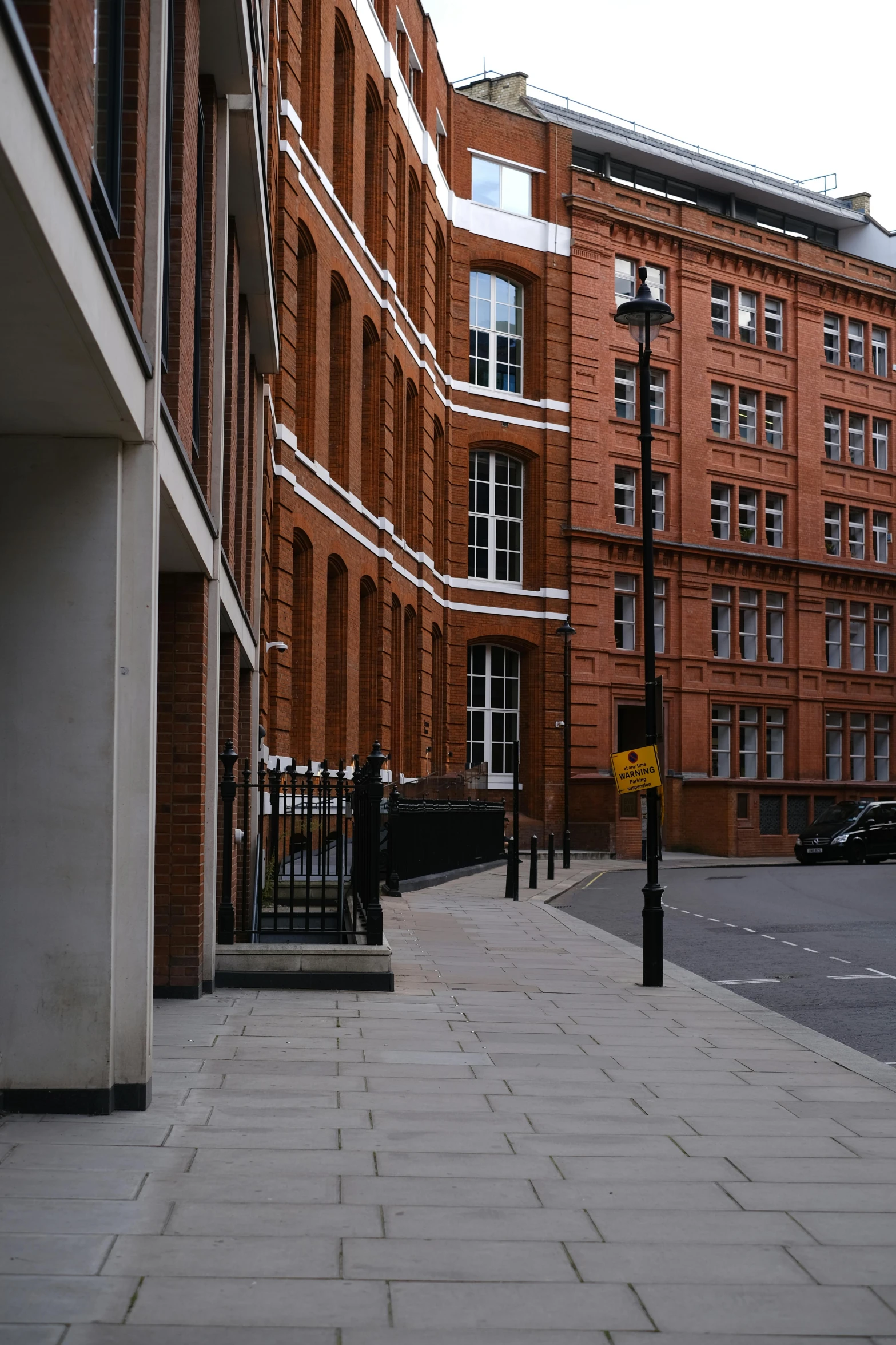 a brick sidewalk next to two buildings