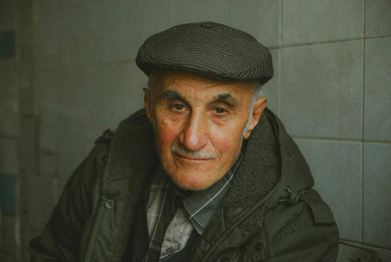 an old man sitting down in a bath room