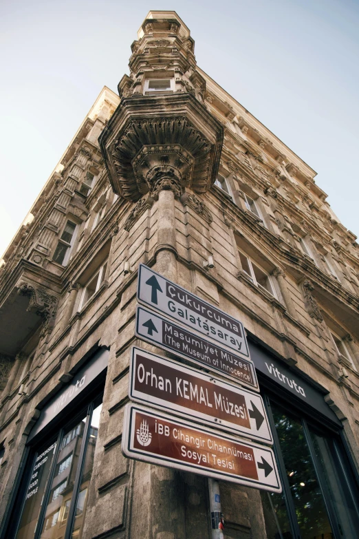 an ornate stone tower with many signs below