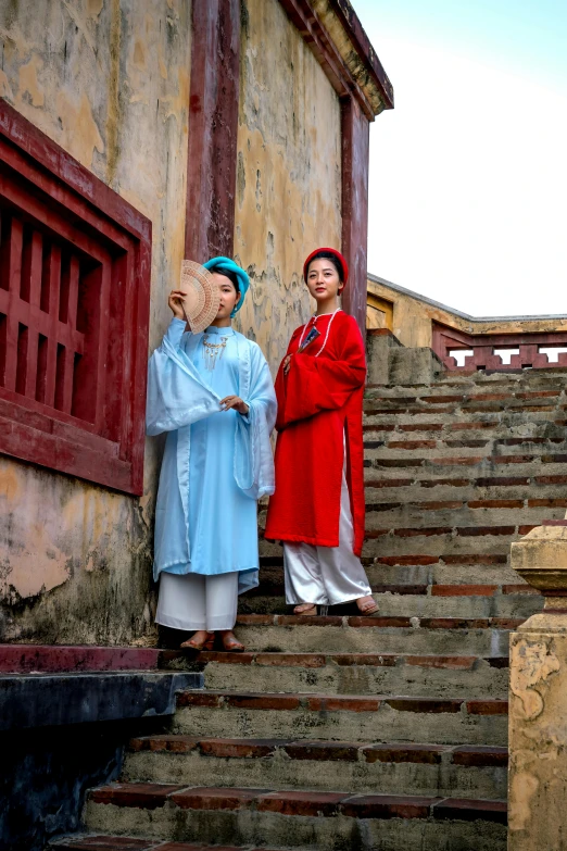 two women are on the steps with some baskets