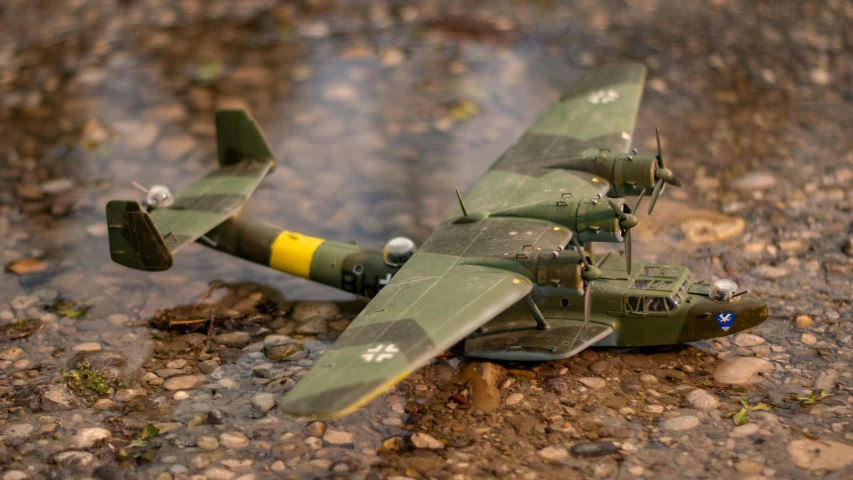 green war plane on ground in dirt area