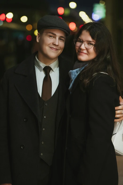 the couple stands side by side on a city street