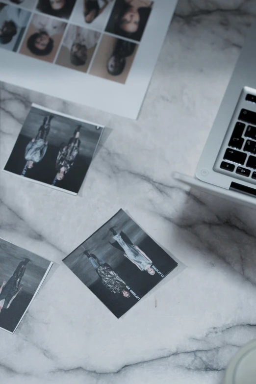 the view of a marble desk with pictures and computer keyboard