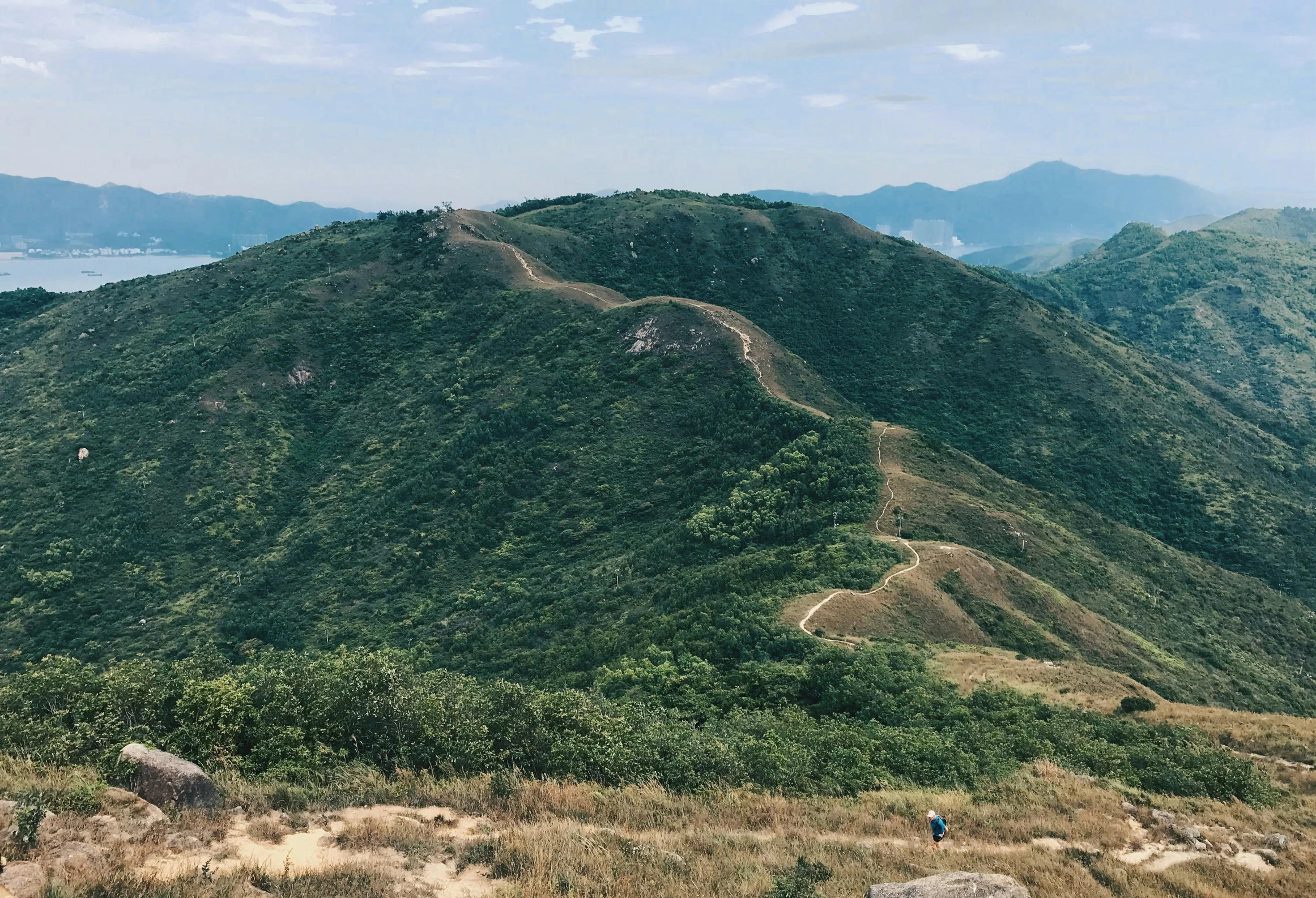 a winding path going down a hill in the mountains