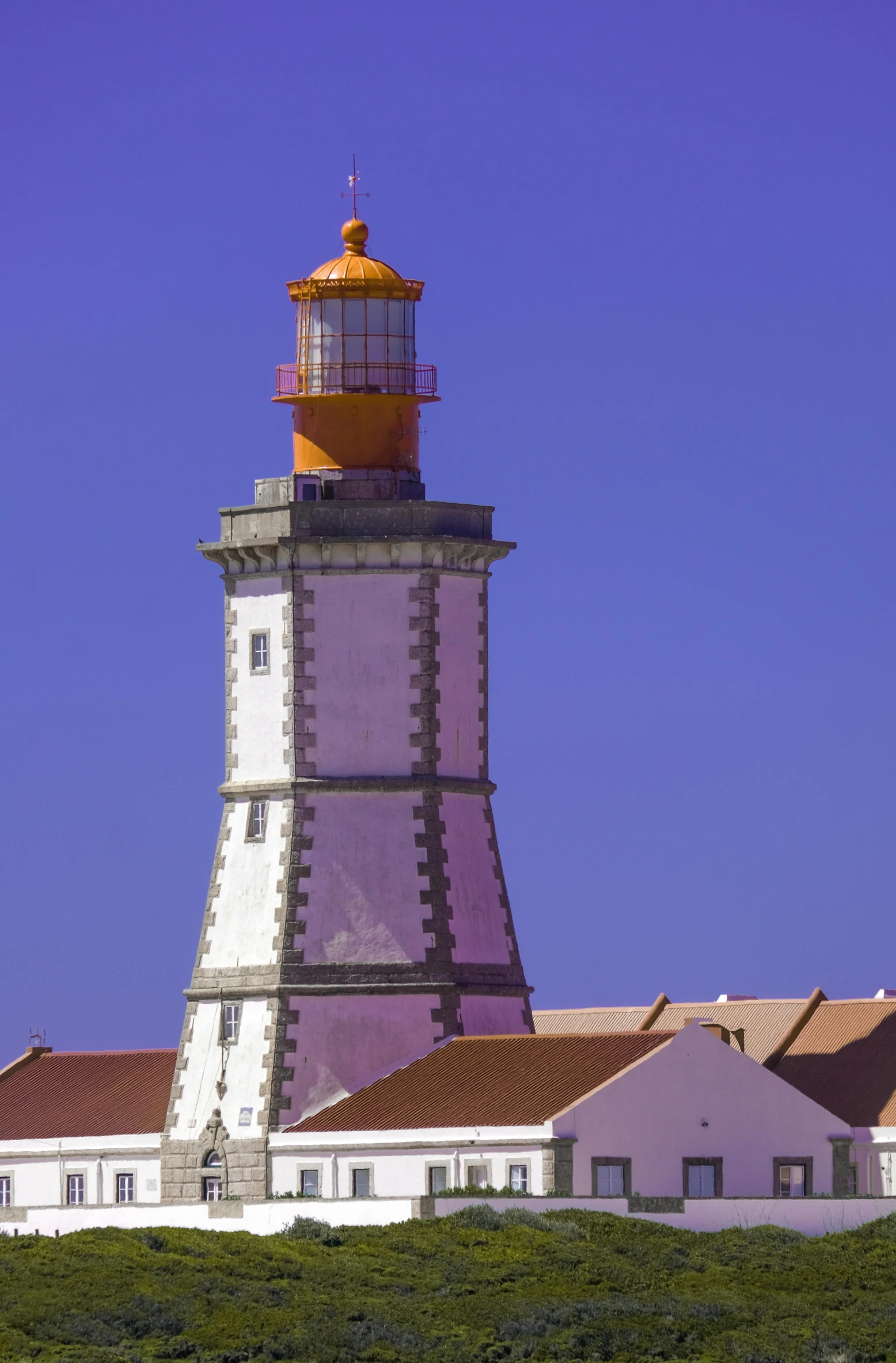 a tall light house sitting on top of a field